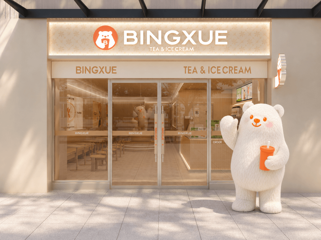 Bobo Bear standing with a drink outside a BINGXUE storefront in Canada